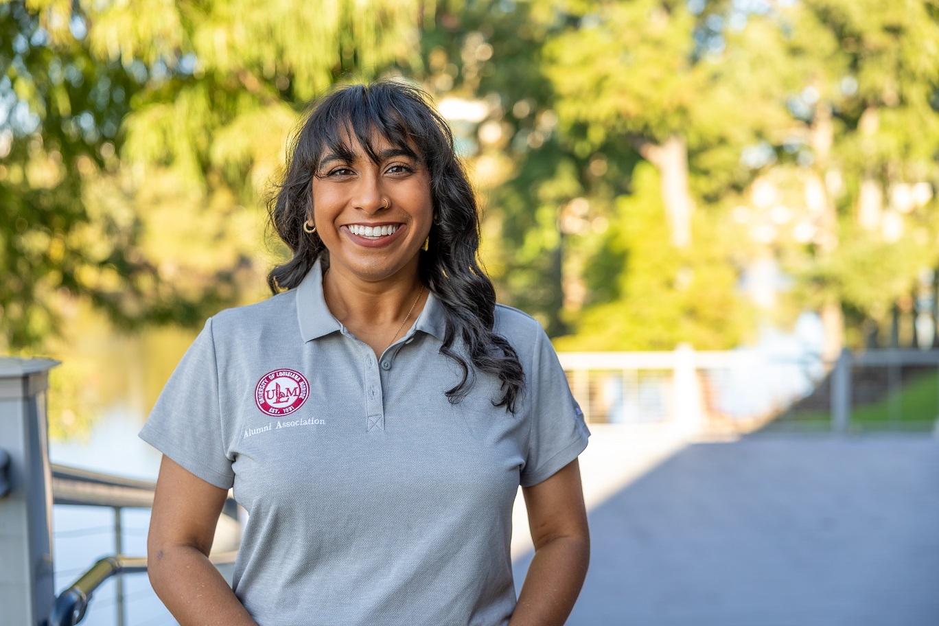 Portrait of Nirali Patel ULM Alumni Association Board Member, standing on campus near the bayou.