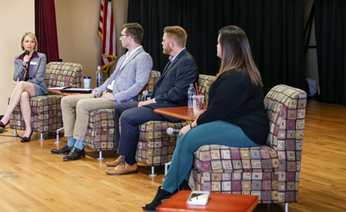 Professor and panelists engaged in discussion