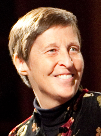 Composer Gwyneth Walker is smiling and wearing a turtleneck.