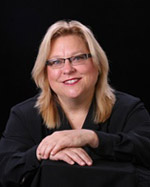 Dr. Deborah Chandler is seated, wearing black clothes