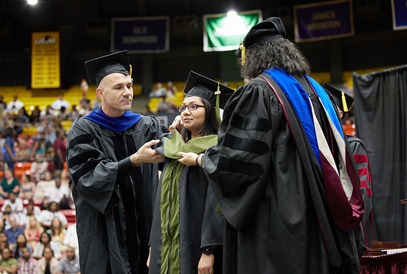 ULM COP Graduate student being hooded at ULM graduation.