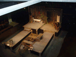 Aerial view of the stage in Black Box Theatre. Several pieces of set and set decoration are visible.